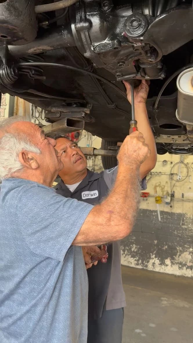 Mike and Darwin working under a car on the lift