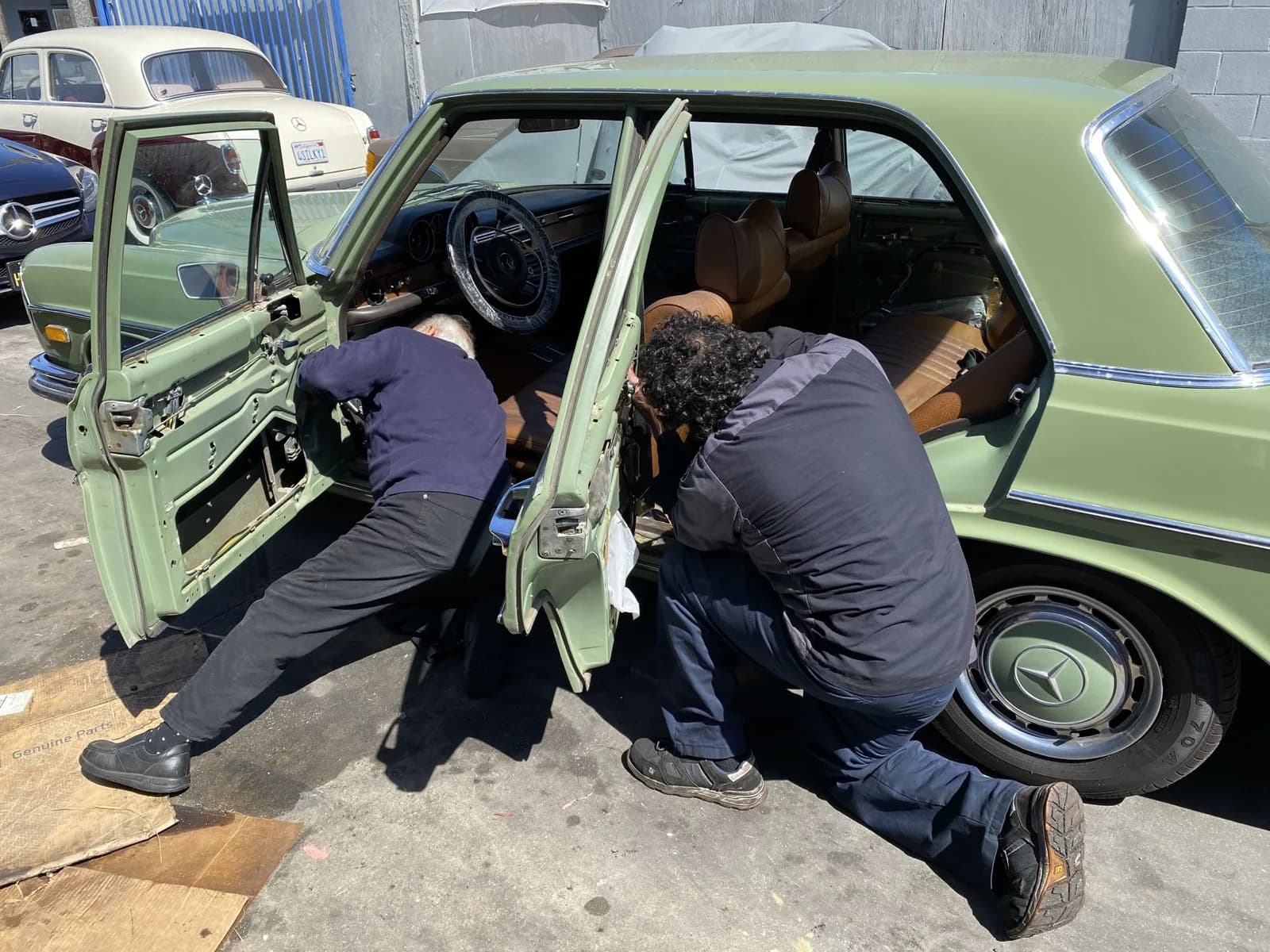 Mike and the team working on a green W123 Mercedes door panel
